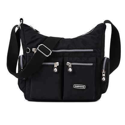 Black multi pocket crossbody bag for women with multiple zippered compartments and adjustable strap