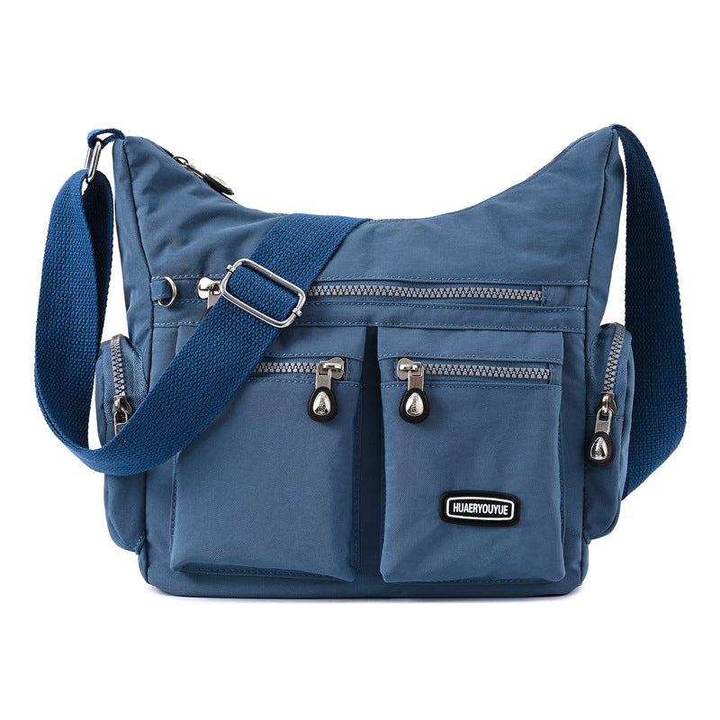 Blue multi pocket crossbody bag for women featuring adjustable strap and multiple compartments