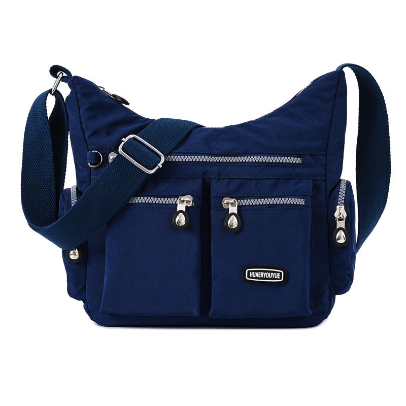 Navy multi pocket crossbody bag for women with adjustable strap and zippered compartments