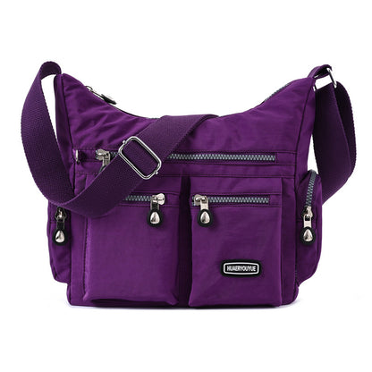 Purple multi pocket crossbody bag for women featuring multiple zippered pockets and adjustable strap