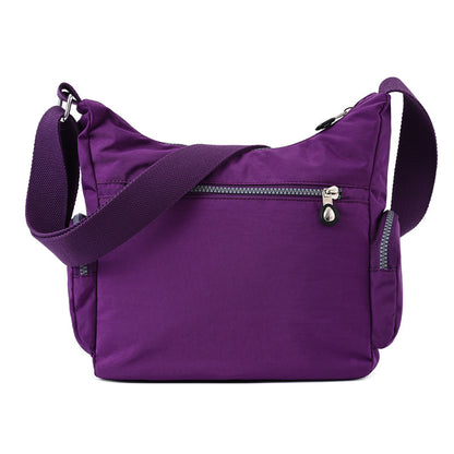 Purple multi pocket crossbody bag for women featuring an adjustable strap and zippered pockets