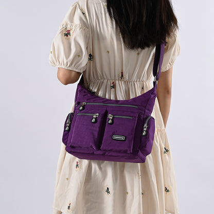 Purple multi pocket crossbody bag for women featuring multiple secure zip compartments