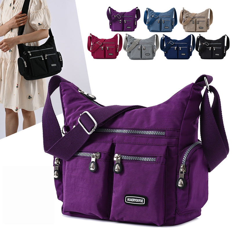 Purple multi pocket crossbody bag for women with adjustable strap and multiple zipper compartments