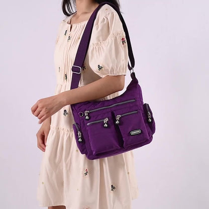 Purple multi pocket crossbody bag for women with adjustable strap and stylish design