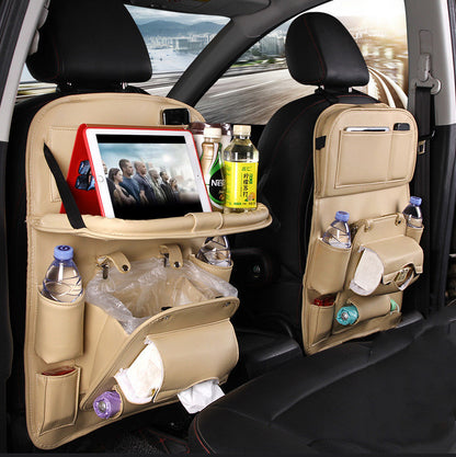 Beige multifunction car seat tray organizer hanging on car seat back with tablet, bottles, and storage compartments