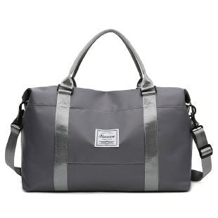 Stylish gray women's travel duffel bag with adjustable straps, perfect for travel, featuring durable material