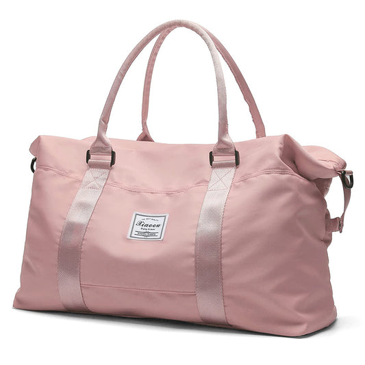 Pink women's travel duffel bag with sturdy handles and spacious interior for weekend getaways