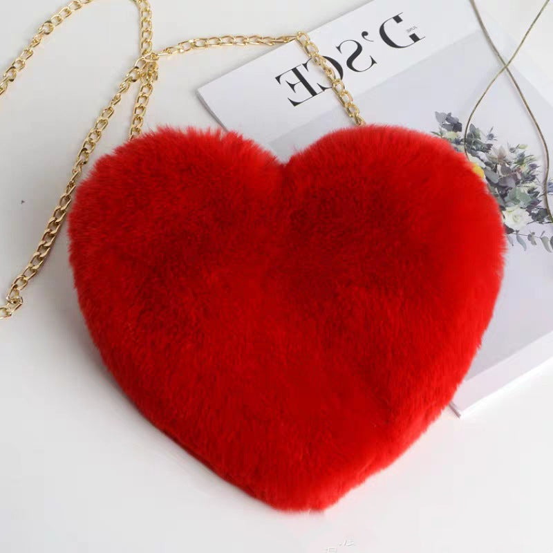 Red plush heart shoulder bag for women with a gold chain strap for stylish outings
