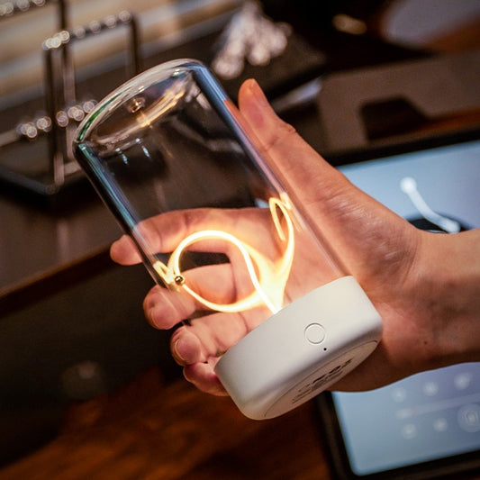 Hand holding a portable rechargeable night lamp with Type-C featuring a clear glass cover and warm filament light