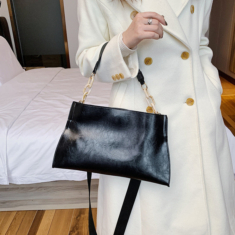 Stylish black retro crossbody bag for women with a chic chain strap and sleek design