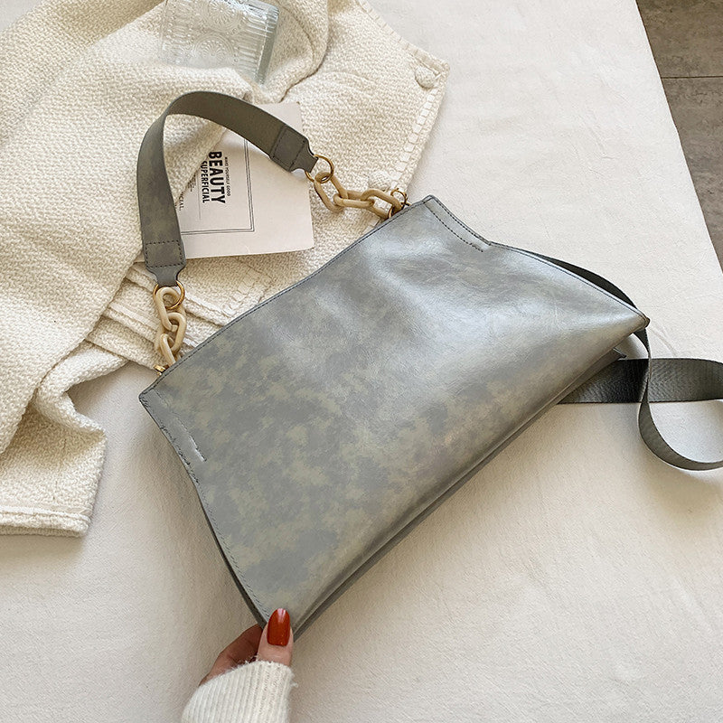 Stylish grey retro crossbody bag for women with sleek design and gold accents