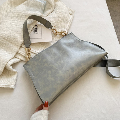 Stylish grey retro crossbody bag for women with sleek design and gold accents