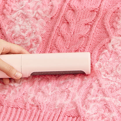 Hangzhou Jingqian reusable pet hair remover brush cleaning white pet hair from a pink knitted sweater