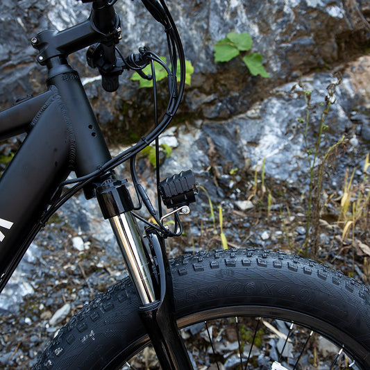 Close-up of front suspension and tire on a professional 1000W electric mountain bike by Hangzhou Jingqian