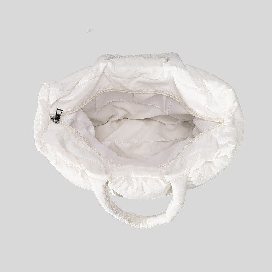 Interior view of a soft cotton down handbag with a spacious white design and durable handles