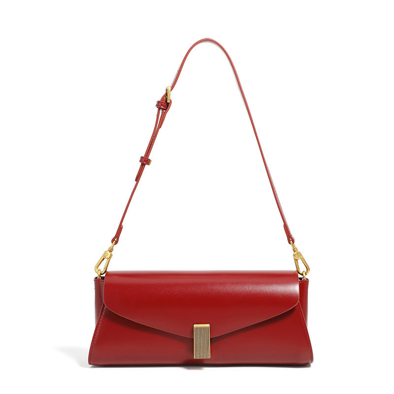 Red leather fashionable shoulder bag for women with gold-tone clasp and adjustable strap