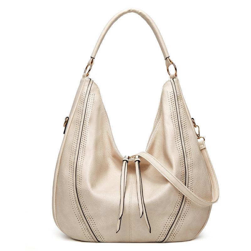 Cream retro large tote shoulder bag with perforated details and dual handles for versatile carrying
