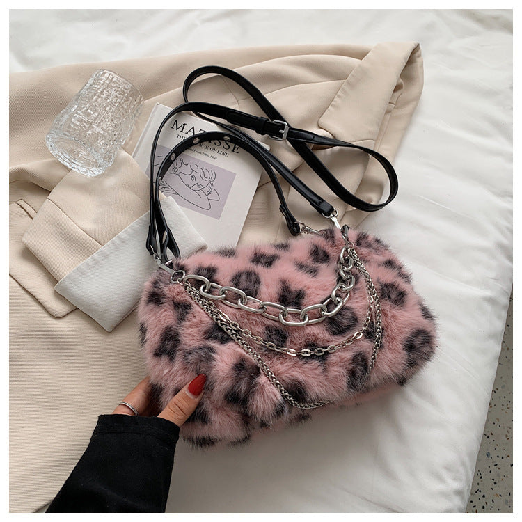Winter plush floral shoulder bag in pink with chain detail and black straps for stylish winter outfits