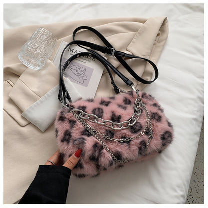 Winter plush floral shoulder bag in pink with chain detail and black straps for stylish winter outfits