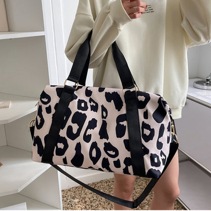 Stylish women’s cow print duffel bag with durable straps for travel and gym use