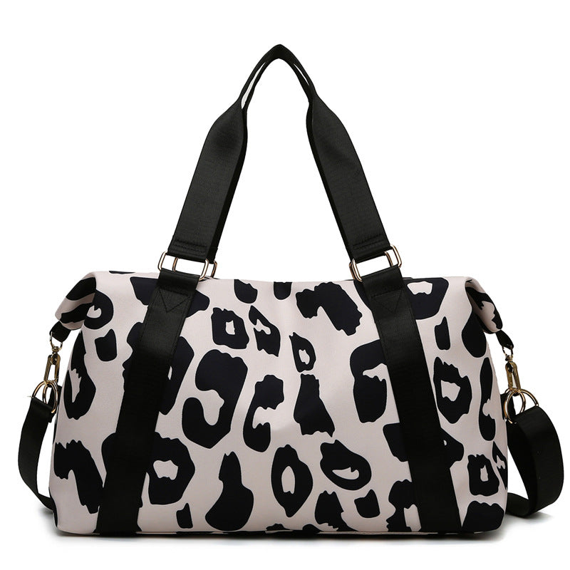 Stylish women’s cow print duffel bag with durable straps for travel and gym use