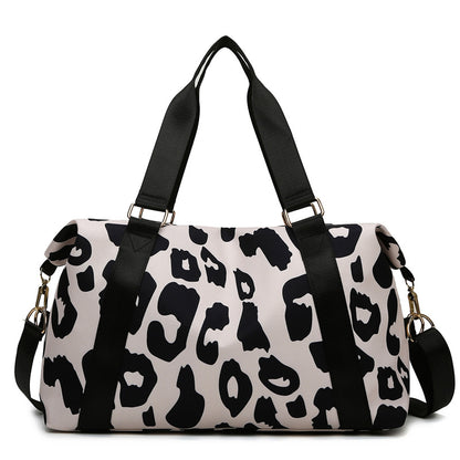 Stylish women’s cow print duffel bag with durable straps for travel and gym use
