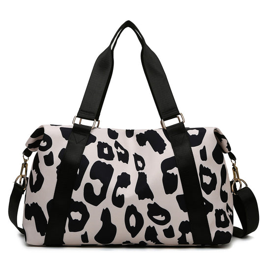 Stylish women’s cow print duffel bag with durable straps for travel and gym use