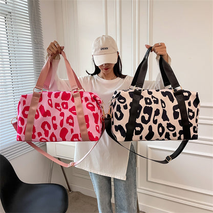 Stylish women’s cow print duffel bag in pink and black designs, perfect for travel and gym use