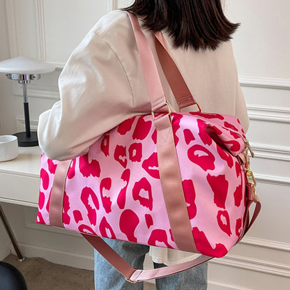 Stylish women’s cow print duffel bag with pink leopard design and adjustable straps