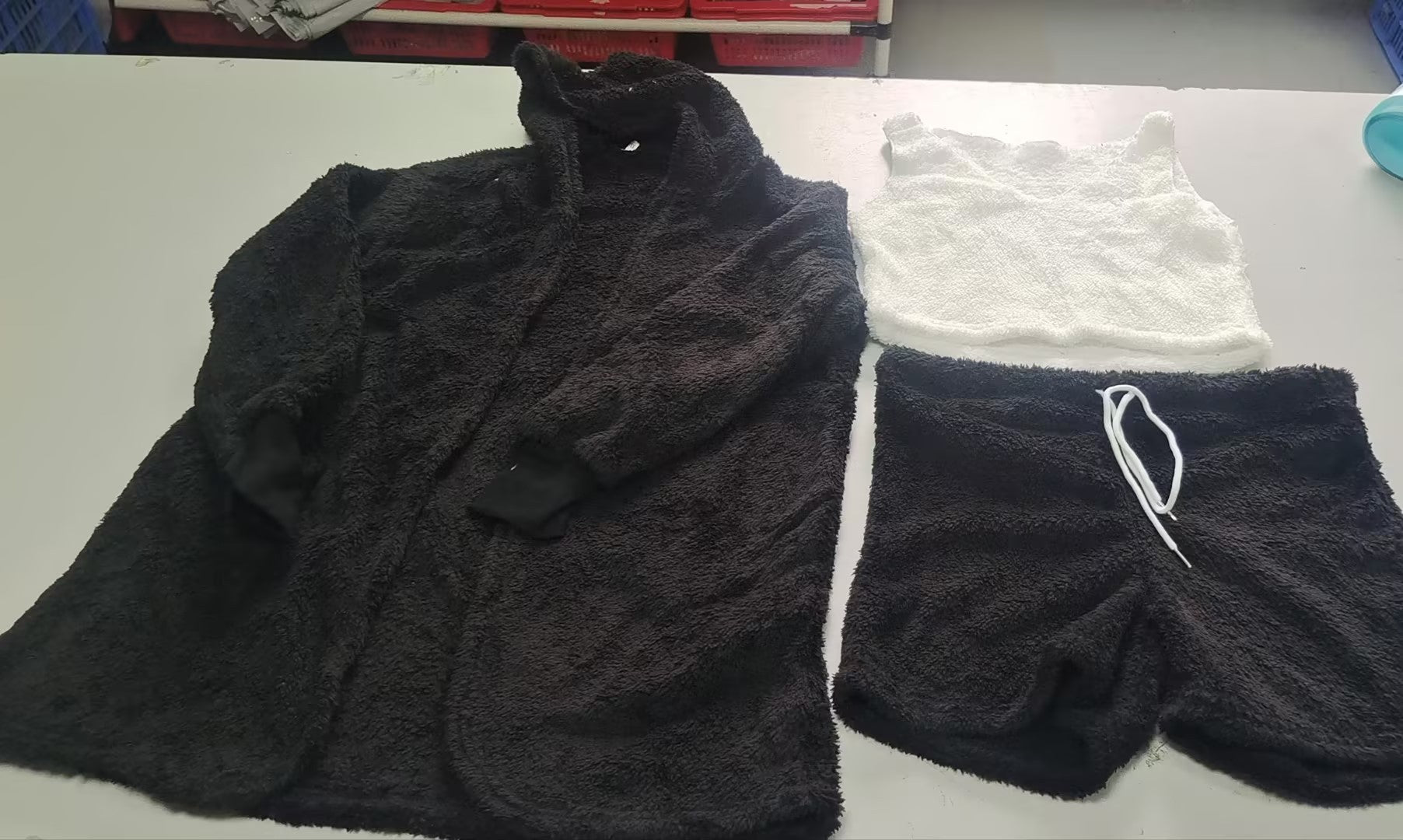 3 piece cozy loungewear outfit including black fuzzy hoodie, white crop tank top, and black shorts