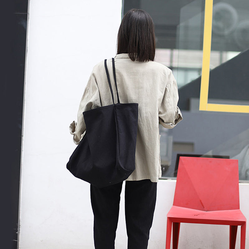 Fashionable woman carrying a women's large canvas tote bag in a minimalist style