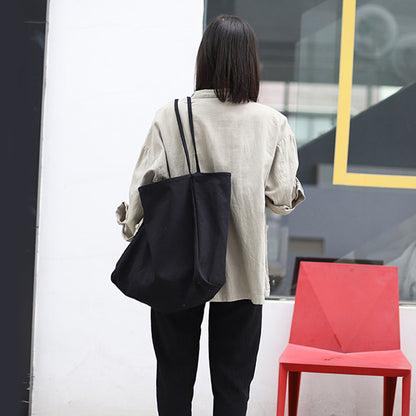 Fashionable woman carrying a women's large canvas tote bag in a minimalist style