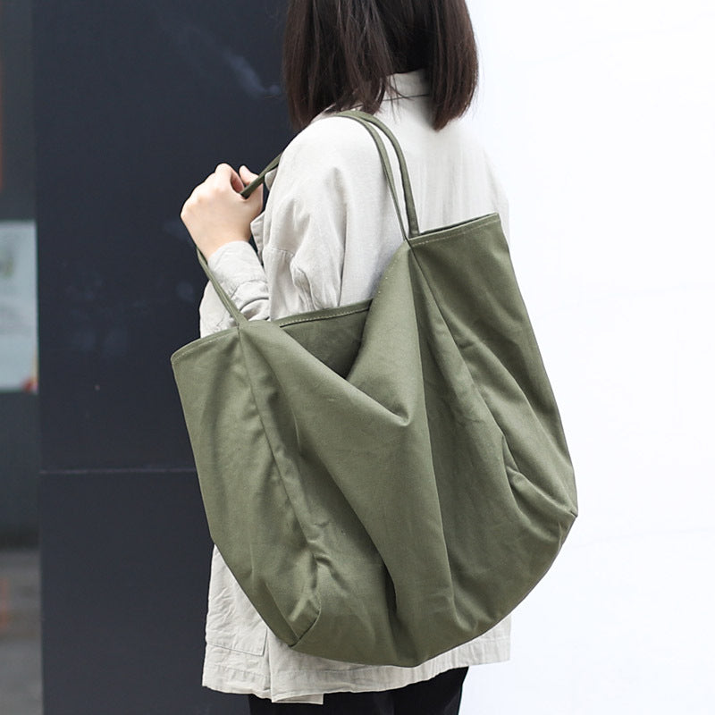 Women's large canvas tote bag in olive green, perfect for everyday use and stylish carrying